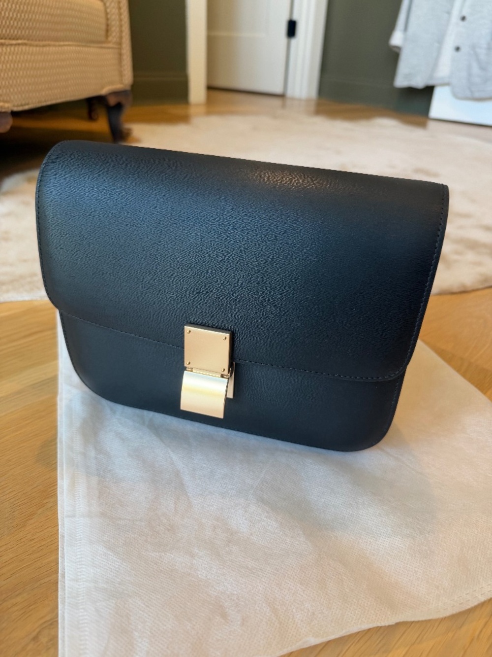 Black shoulder strap bag with gold clasp